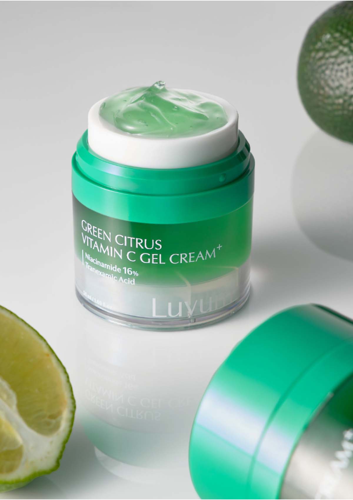 Jar of Green Citrus Vitamin C Gel Cream with a lime on a light gray background